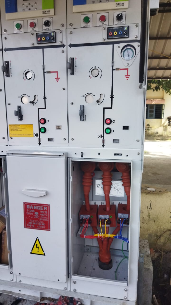 An 11000 volt switchgear panel with protection relays and local control switches, open for inspection