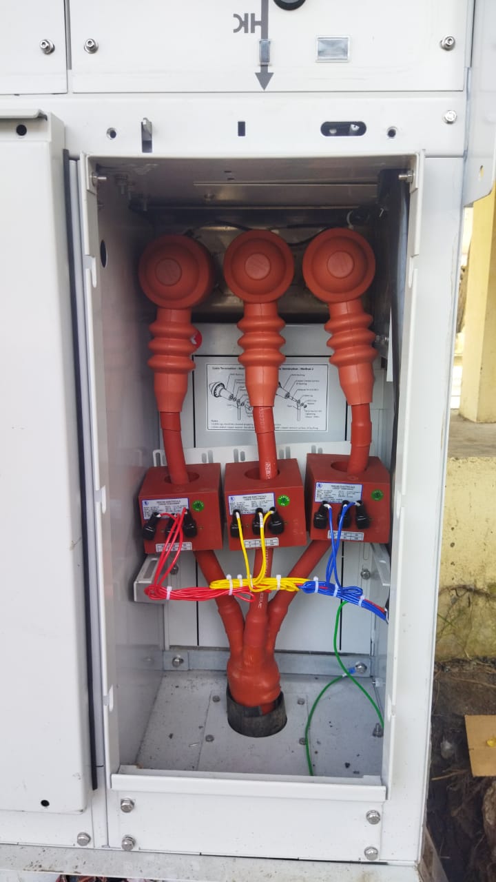 Close-up of cable termination and jointing inside a switchgear panel, with colour-coded conductors