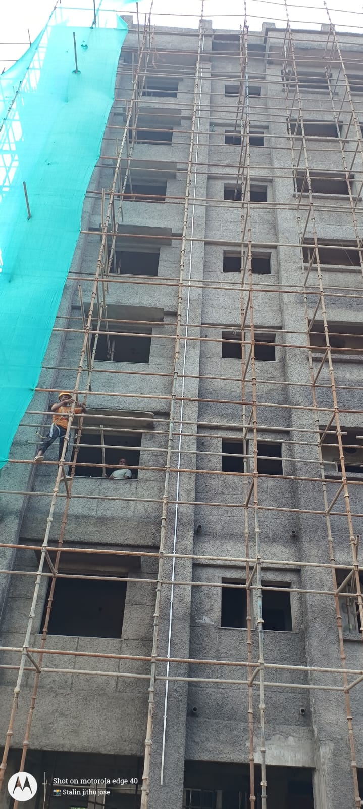 An Ablaze Enterprises technician working on scaffolding at a multi-storey residential building under construction